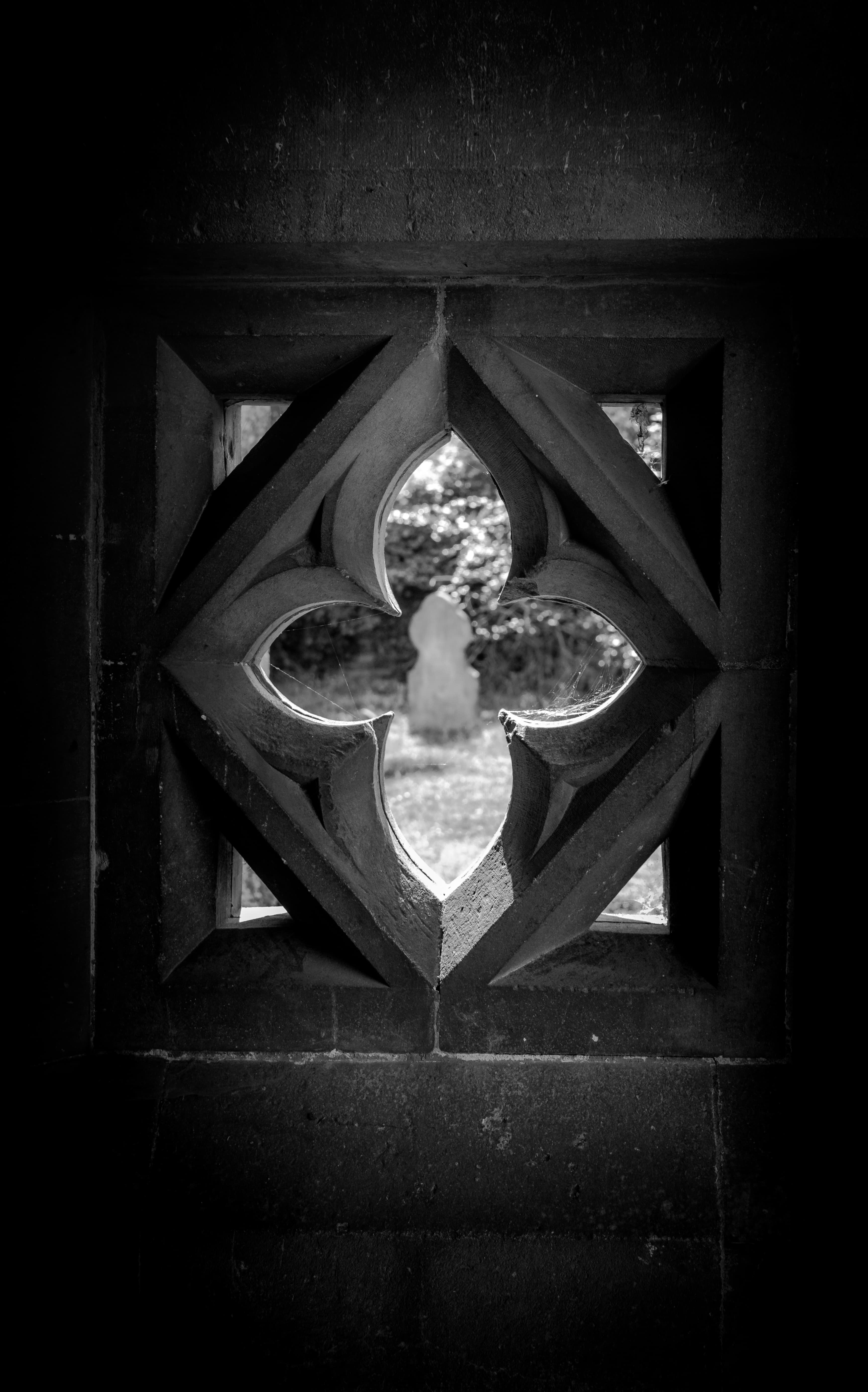 Stone window and gravestone.