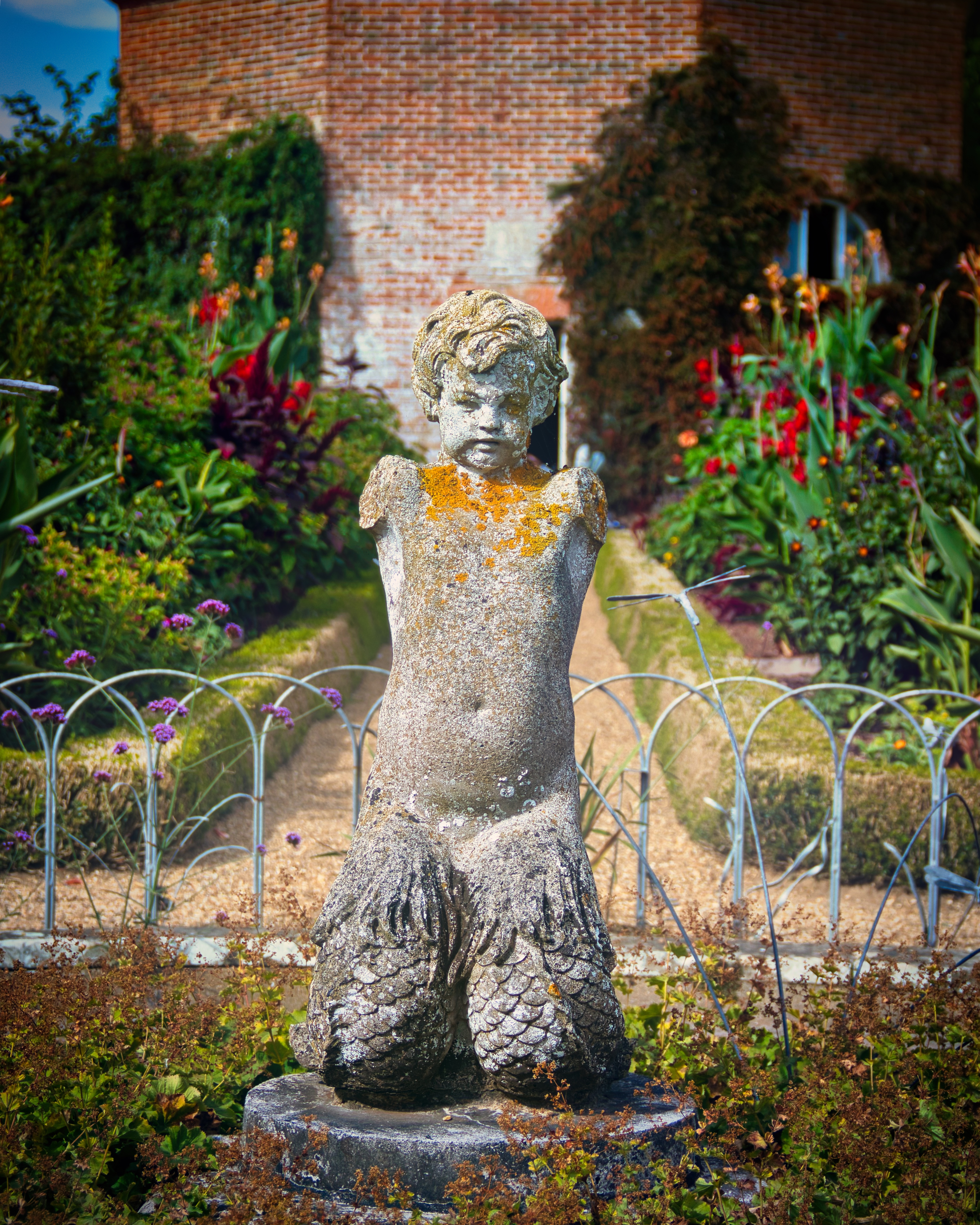This enchanting statue, reminiscent of a garden guardian, exudes a sense of serene elegance and timeless beauty. Its weathered stone texture, adorned with a delicate patina, tells a story of age and history, inviting viewers to imagine the tales it could tell. The statue's composition, with its serene posture and the vibrant garden backdrop, creates a perfect balance of nature and art. Its aesthetic appeal lies in its ability to add a touch of the outdoors to any indoor space, making it a perfect focal piece for a living room or a executive office. The warm lighting of the garden in the background enhances the statue's ethereal quality, making it a perfect addition to a modern gallery wall, where it can inspire and captivate all who see it.