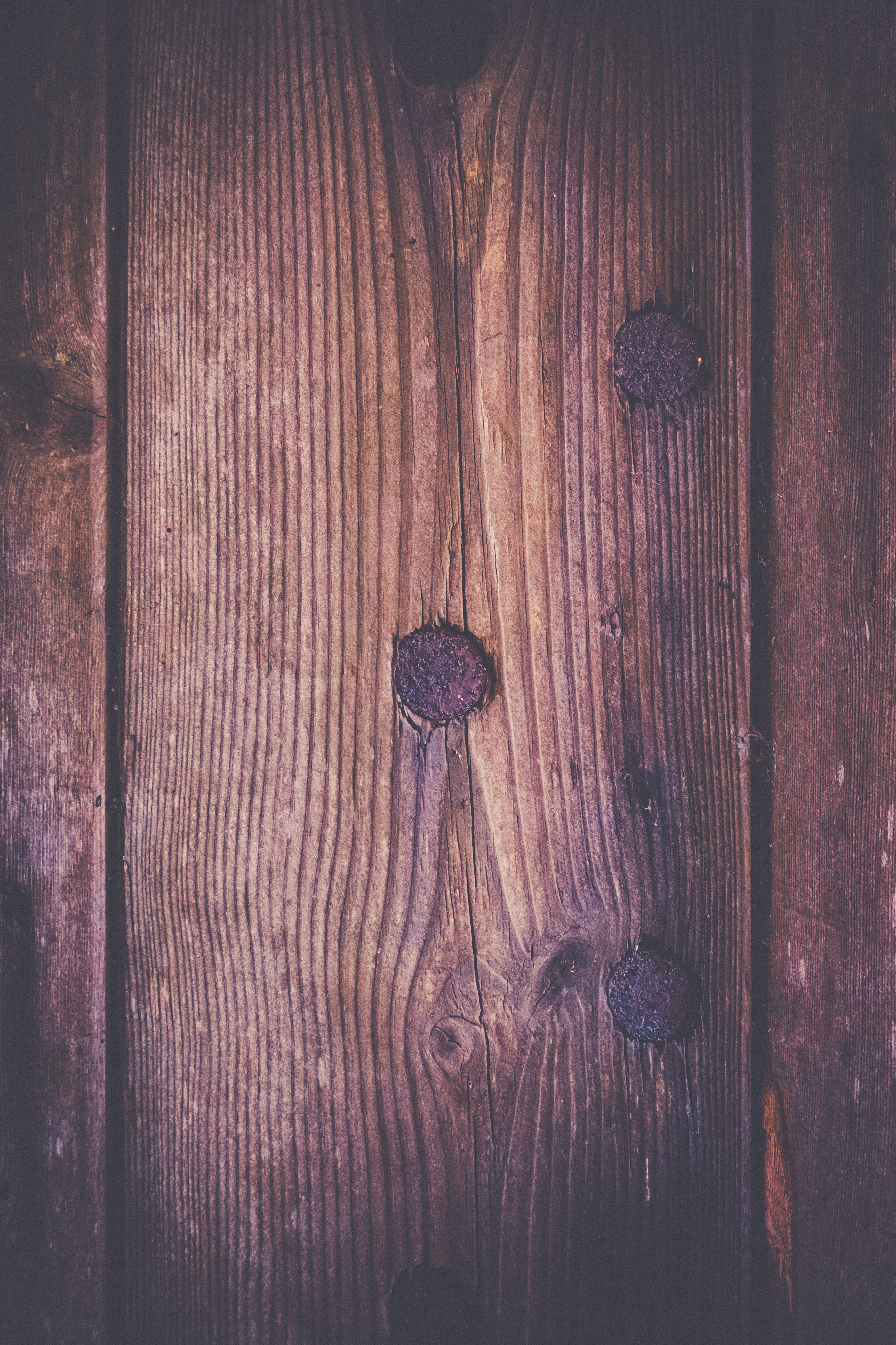 This photograph captures the rustic charm of weathered wood, with its rich, earthy tones and subtle variations in grain. The soft, diffused lighting enhances the natural beauty of the wood, creating a perfect backdrop for any modern minimalist aesthetic. The composition, with its vertical lines and natural knots, adds a perfect balance of organic and geometric elements. This piece is ideal for a executive office, where it can serve as a striking focal point, or for the modern gallery wall, where it can complement other contemporary art pieces. Its versatile nature makes it a perfect addition to any space, adding a warmth and character of nature to any room.
