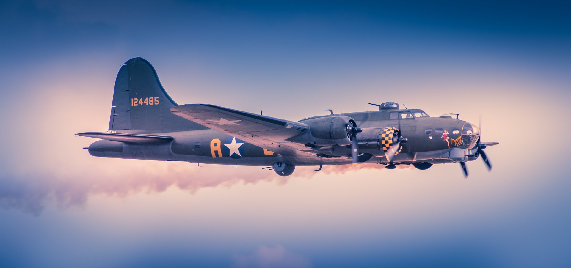 Capture the essence of a classic World War II era B-17 Flying Fortress in this stunning fine-art print. The photograph, bathed in the warm glow of a setting sun, evokes a nostalgia of a past while showcasing the intricate details of the aircraft's design. The composition, with the aircraft soaring gracefully against a backdrop of a sky, creates a perfect balance of action and serenity. This rich, deep tones and the soft lighting make this print a perfect addition to any living room, creating a focal point that speaks of adventure and history. Display it in your executive office to inspire a spirit of innovation and resilience, or in a modern gallery wall of your home to add a perfect touch of vintage charm.
