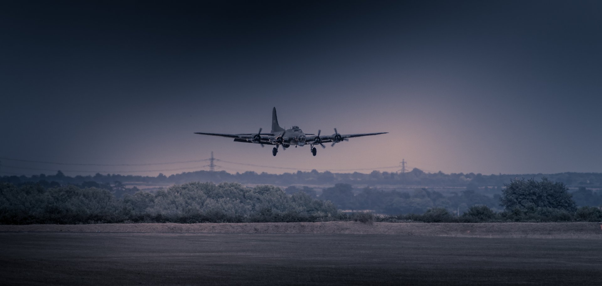 This evocative photograph captures the serene beauty of a vintage aircraft gracefully descending at dusk, its silhouette illuminated against a gradient sky. The composition, with the plane centrally framed, draws the viewer into the tranquil scene, evoking a quiet majesty of aviation history. The soft, muted lighting enhances the mood, creating a perfect backdrop for a modern minimalist or vintage enthusiast. Ideal for a executive office, it serves as a perfect focal point, inspiring a spirit of adventure and the allure of the open skies. Place it in living room to add a perfect touch of sophistication and a hint of nostalgia.