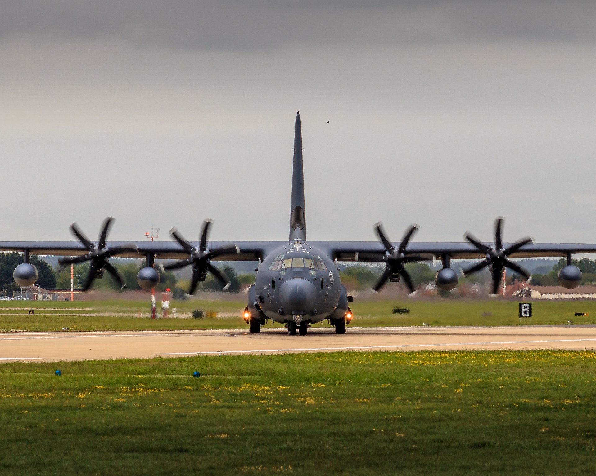 This photograph captures the majestic presence of a military aircraft, its powerful engines and robust design exuding a sense of strength and readiness. The dramatic lighting, with the aircraft silhouetted against a overcast sky, enhances its imposing silhouette, evoking a awe and respect associated with military aviation. The composition, with the aircraft centered and the runway stretching into the distance, creates a perfect balance of power and perspective. This aesthetic appeal lies in its raw, unfiltered beauty, making it a ideal piece for any space that values bold, modern decor. Whether displayed in a living room as a focal point or in an executive office to inspire a spirit of innovation, this image is a perfect blend of art and function.