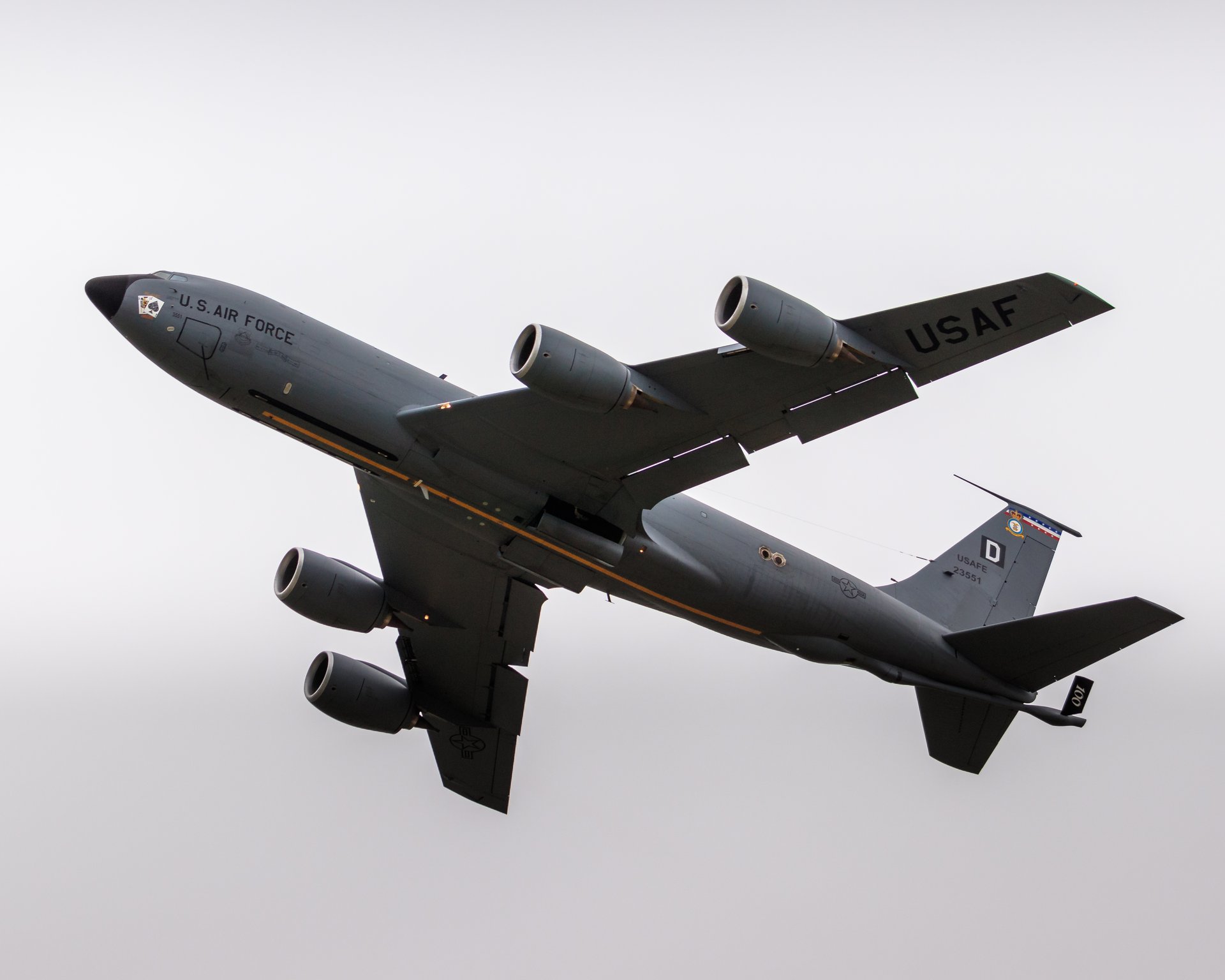 This stunning photograph of a U.S. Air Force aircraft in flight captures the essence of power, precision, and innovation. The high contrast lighting highlights the sleek lines and bold markings of the aircraft, creating a perfect balance of drama and elegance. The composition, with the aircraft angled dynamically against a sky, evokes a feeling of motion and adventure. This rich, dark tones of the aircraft contrast beautifully with the soft, neutral background, making it a perfect focal point for any modern home or office. Display this piece in a living room to inspire awe and conversation, or in an executive office to symbolize strength and leadership. It's a perfect blend of art and aviation history, making it a ideal addition to any gallery wall or statement wall.