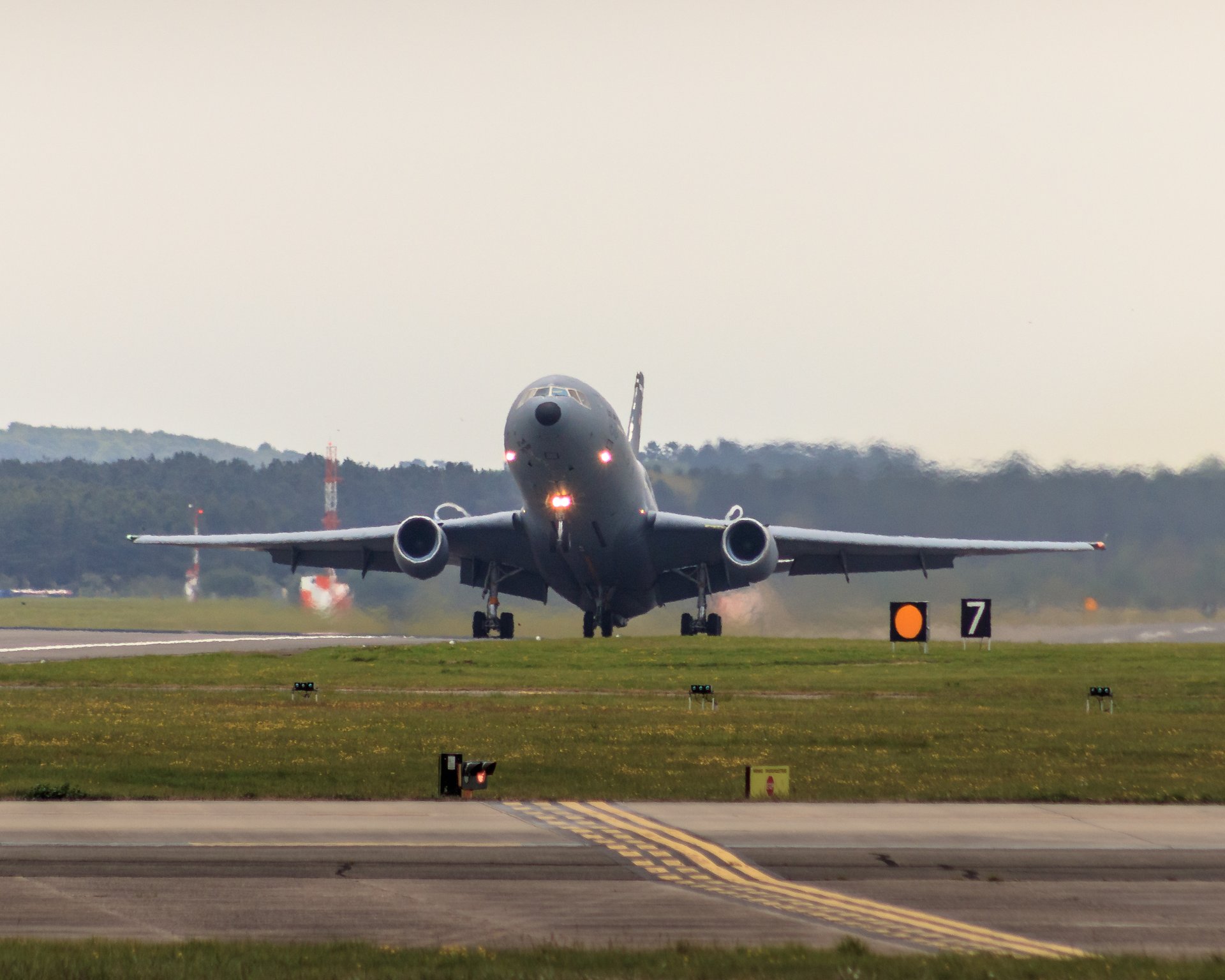 Capture the essence of aviation's grandeur with this stunning photograph of an Airbus A380 landing. The soft, diffused light of the overcast sky enhances the aircraft's sleek, modern design, creating a tranquil yet awe-inspiring scene. The composition, with the aircraft centered and the runway stretching into the distance, draws the viewer's eye, making it a perfect focal point for any living room or executive office. Display this piece to inspire a spirit of adventure and the marvel of human engineering.