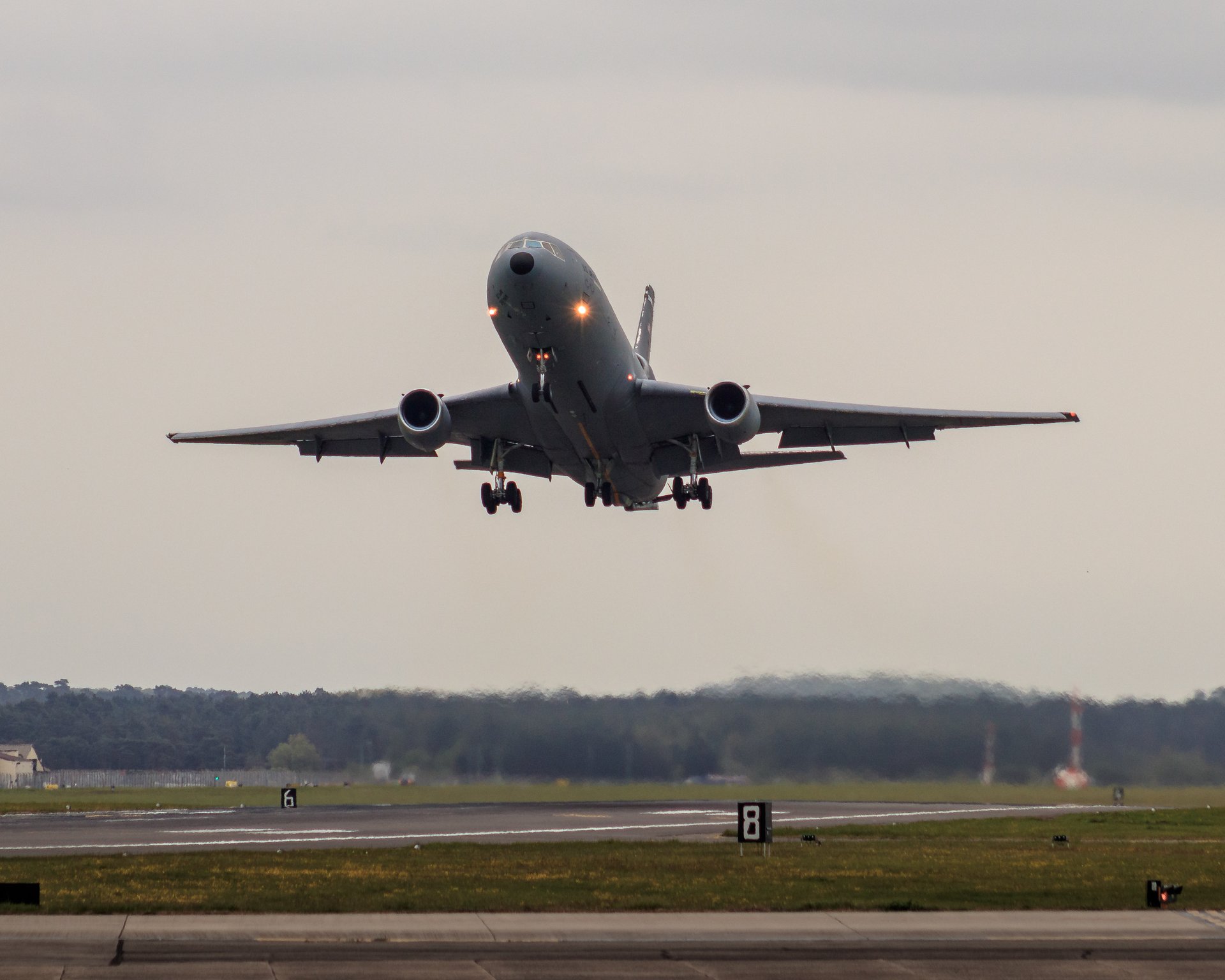 Capture the essence of aviation's grandeur with this photograph of a aircraft's graceful ascent. The soft, diffused light of the setting or rising sun bathes the plane in a perfect light, creating a serene and majestic mood. The composition, with the aircraft centered and the horizon subtly blurred, draws the viewer's eye to the beauty of the moment. This image's aesthetic appeal lies in its balance of motion and stillness, making it a perfect piece for a living room focal point or an executive office's gallery wall, where it can inspire a spirit of adventure and the pursuit of dreams.