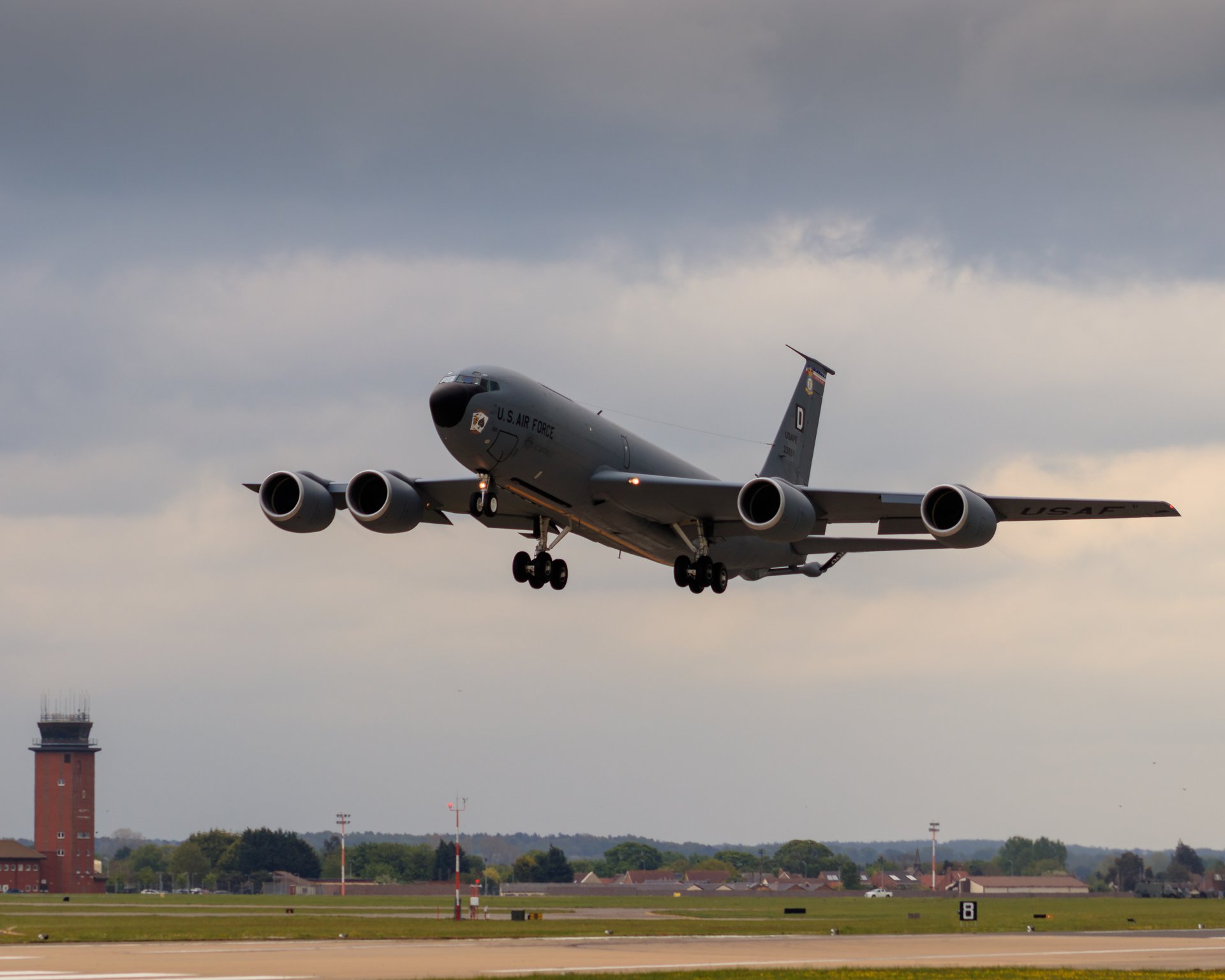 Capture the essence of aviation with this striking photograph of a military transport aircraft in flight. The image exudes a sense of power and precision, with the aircraft's sleek design and powerful engines set against a dramatic backdrop of a cloudy sky. The composition, with the aircraft angled slightly upward, evokes a feeling of ascension and adventure. The rich, muted tones of the photograph add a perfect touch of sophistication, making it a ideal focal point for any modern gallery wall or executive office. Display this piece to inspire a sense of awe and admiration for the marvels of aviation and engineering.