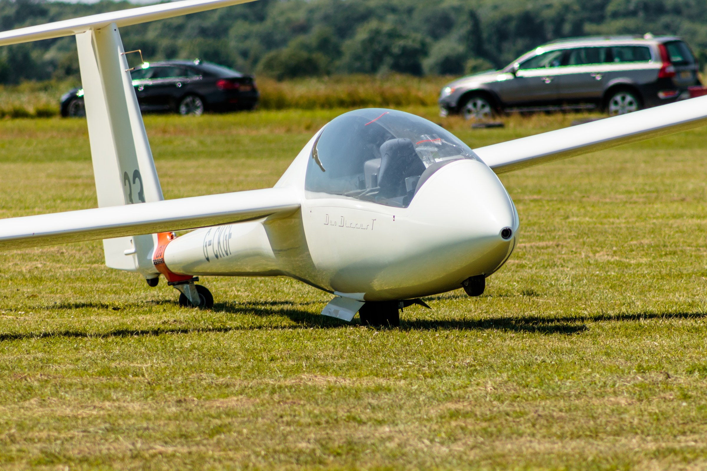 Capture the essence of tranquility and precision with this stunning photograph of a Schleicher ASW 17 glider. The image, bathed in natural sunlight, exudes a calmness of a serene day at the airfield. The composition, with the glider positioned centrally, draws the viewer's eye to the sleek, modern lines of the aircraft, evoking a feeling of flight and freedom. This vibrant green grass and the soft shadows add depth and a perfect balance of color, making this piece ideal for a living room focal point or an executive office where it can inspire a spirit of adventure and innovation. Hang it in a corner of your modern gallery wall to add a touch of sophistication and a hint of the outdoors to your interior design.