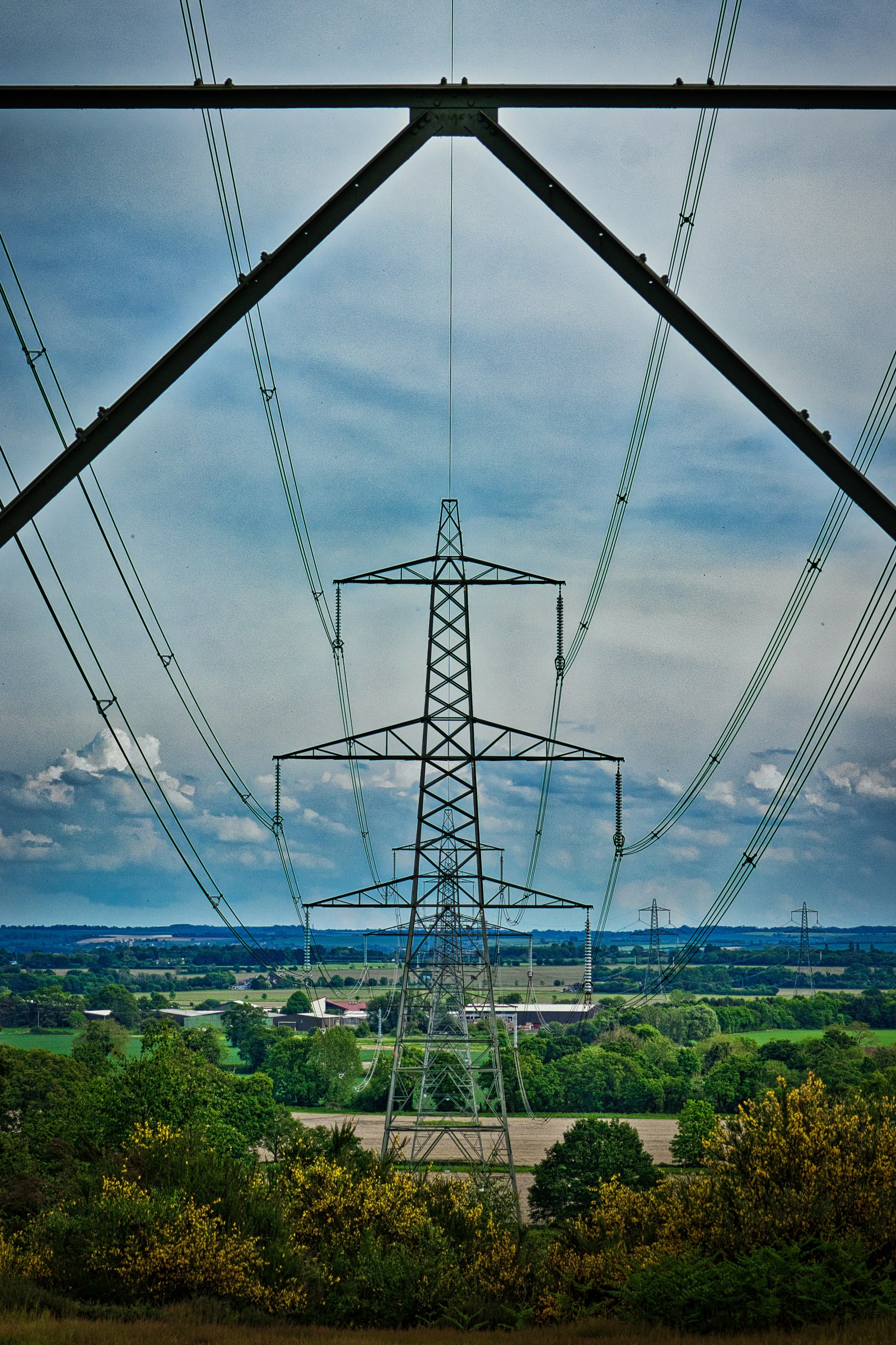 This stunning fine-art photograph captures the intricate beauty of power lines against a backdrop of a sky, creating a striking contrast between industrial and natural elements. The composition, with its symmetrical lines and vibrant colors, evokes a mood of both serenity and industrial strength. The image's aesthetic appeal lies in its ability to transform any space into a a modern gallery piece, perfect for executive offices, living rooms, or modern art collections. Display it as a a focal point in living room to inspire conversations or as a statement piece in an executive office to reflect a balance of innovation and nature.