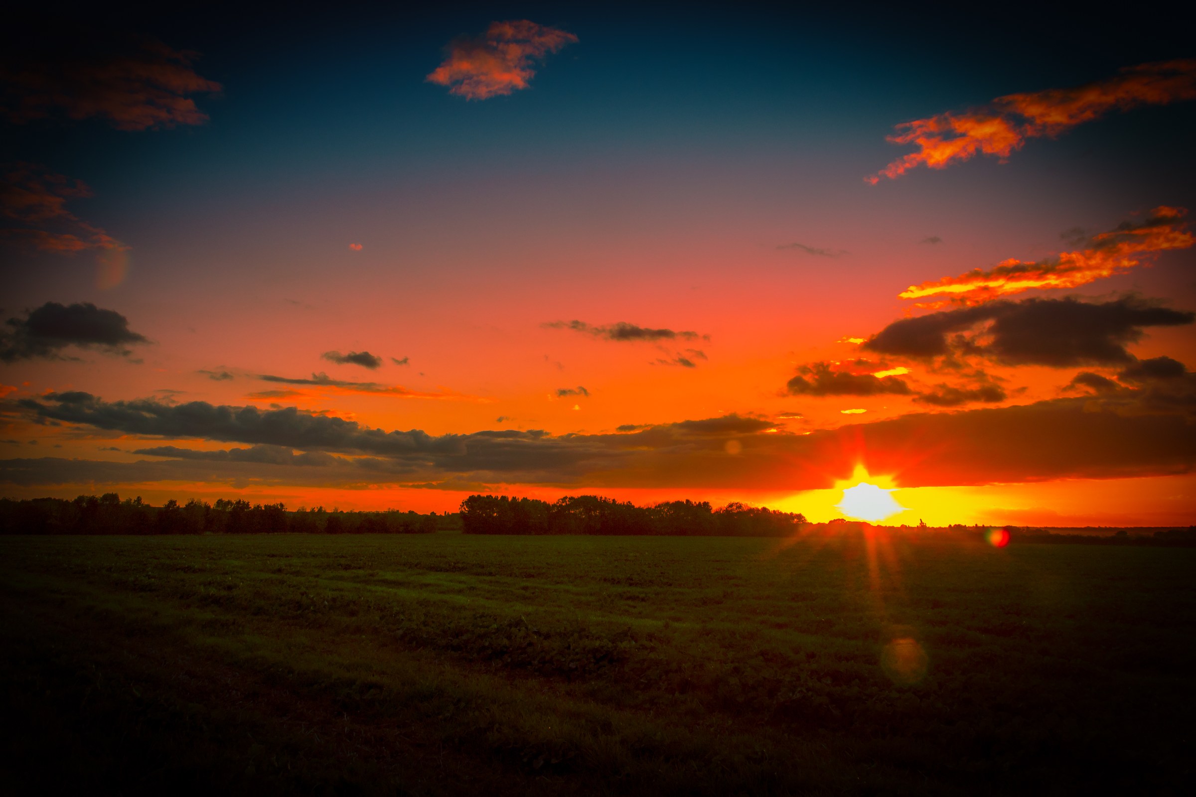 This breathtaking photograph captures the serene beauty of a sunset, with the sun casting a sky in warm hues of orange and red. The composition is balanced, with the sun positioned slightly off-center, creating a dynamic focal point. The soft, diffused light enhances the tranquil mood, making it perfect for any space that needs a calming effect of nature. Whether displayed in a living room as a a focal piece or in an executive office to inspire creativity, this image exudes a sense of peace and tranquility, making it a true masterpiece for fine-art wall decor.