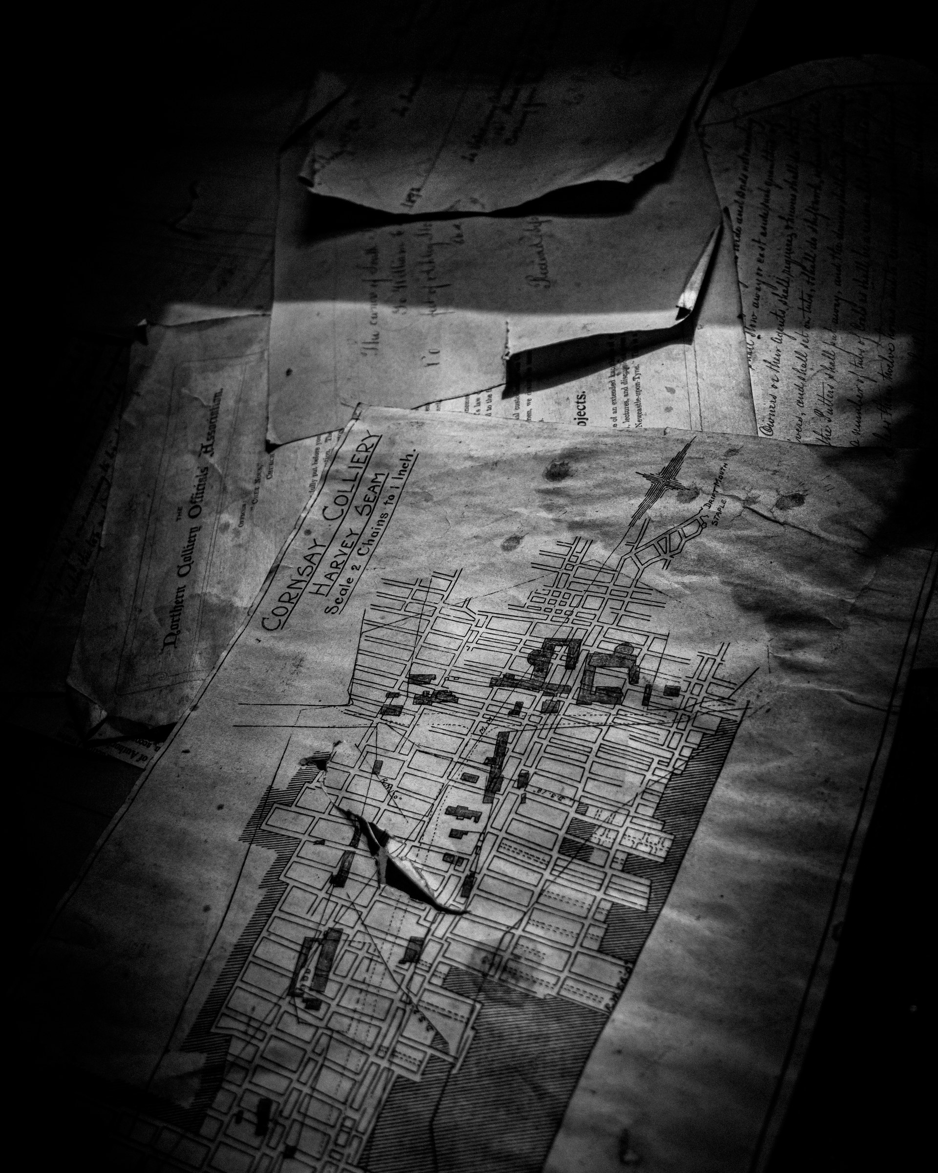 This evocative black and white photograph captures the essence of a past, featuring a intricate details of a Cobrasa & Co. Co. Land & Building Company map. The dramatic lighting and shadow play create a moody, atmospheric feel, perfect for adding a charm of history to any modern space. The composition, with its focus on the map, invites viewers to explore the stories and architecture of the era it represents. Ideal for a living room as a centerpiece of a decor, or as a executive office's focal point, this piece is a stunning blend of vintage charm and contemporary style.