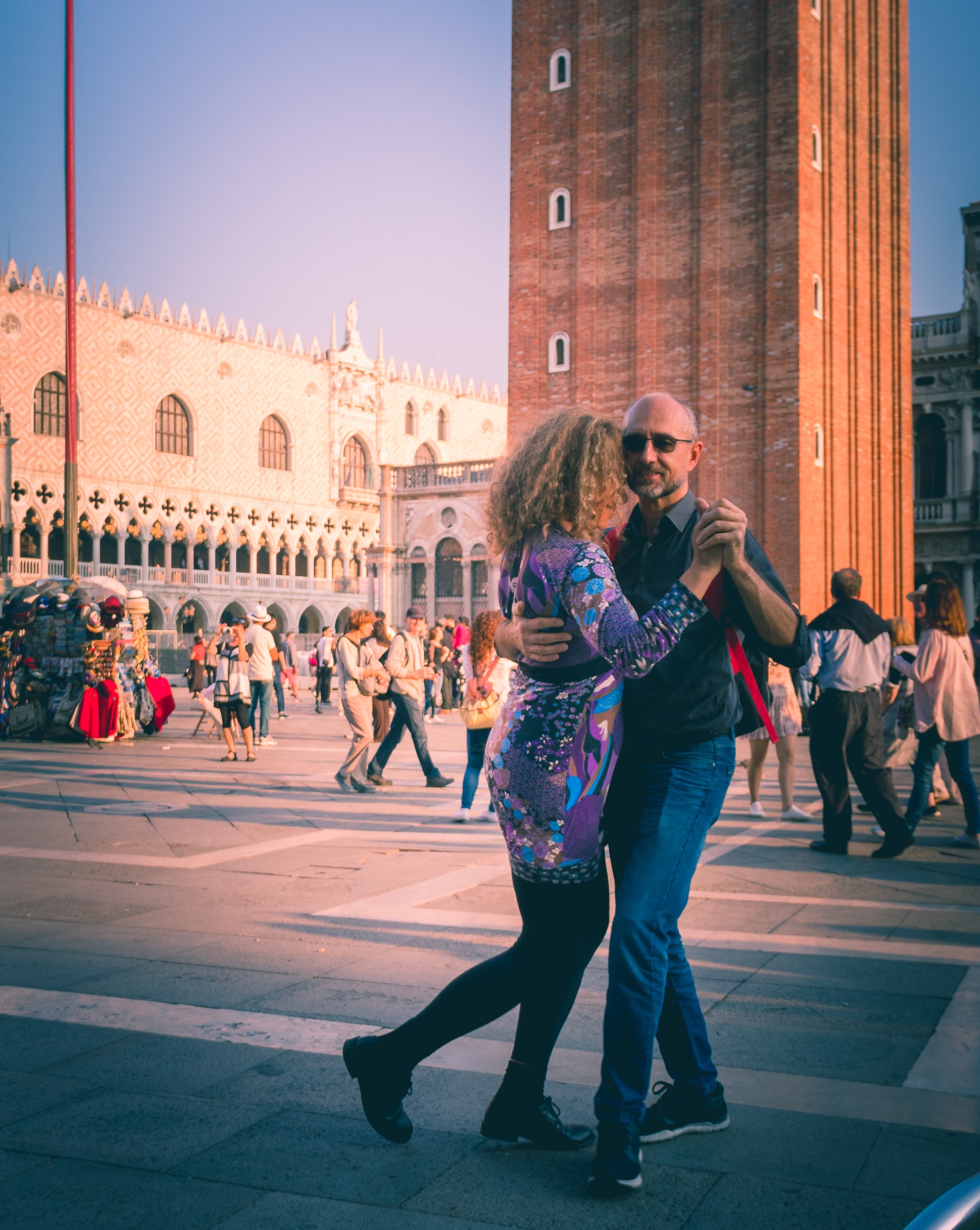 This photograph captures a timeless beauty of a couple dancing in night away in the warm, golden light of sunset. The vibrant colors and dynamic composition evoke a sense of joy and intimacy, making it a perfect piece for a living room focal point or a executive office's gallery wall. The image's aesthetic appeal lies in its ability to transport viewers to a moment of pure, romantic connection, making it a ideal choice for those seeking to infuse their space with a touch of elegance and emotion.