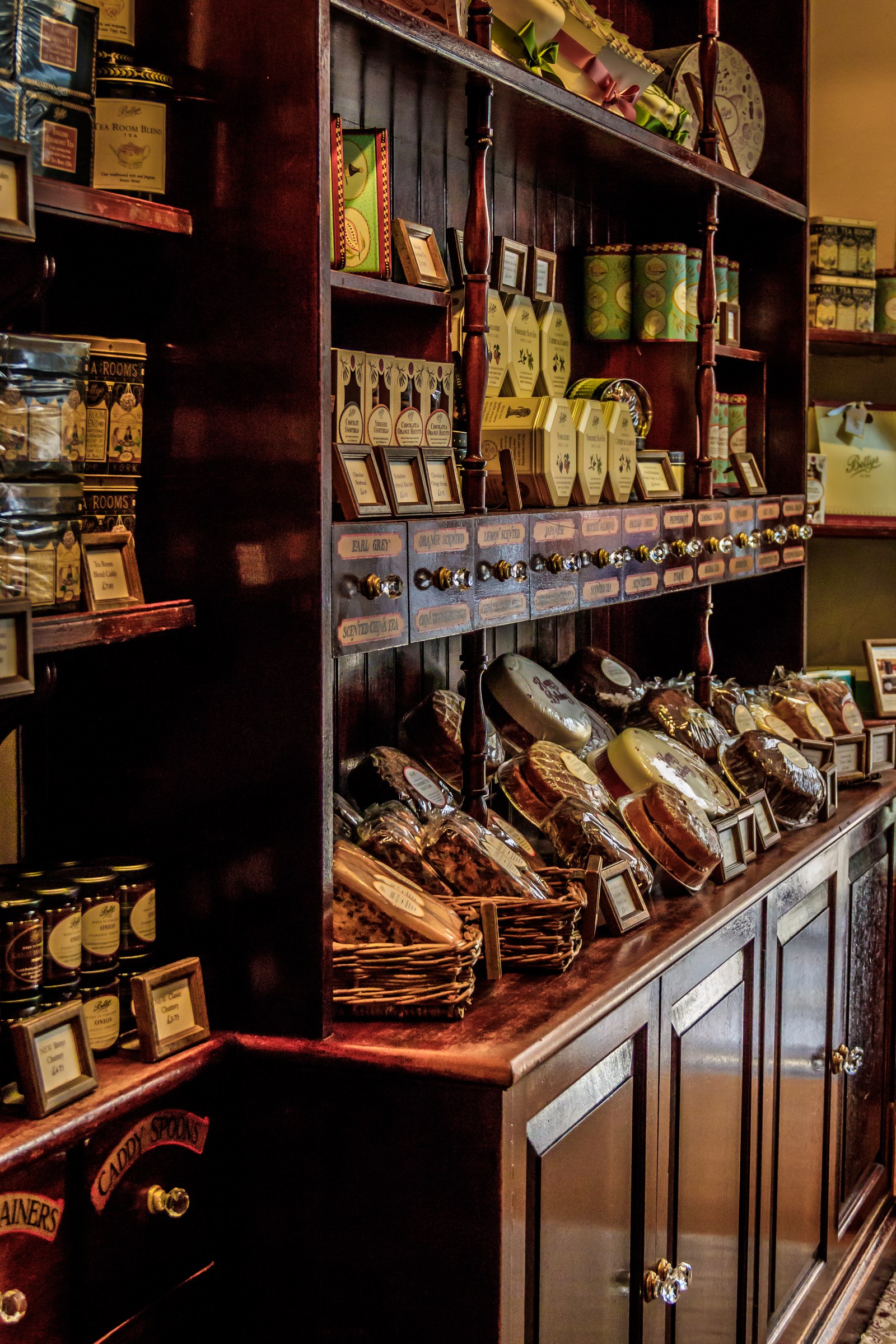 This photograph captures the essence of a vintage apothecary, where the warm, ambient lighting accentuates the rich, dark wood tones and the array of antique jars and bottles. The composition is meticulously arranged, with each shelf and cabinet showcasing a intricate details of the items, evoking a charm of a past. The aesthetic appeal lies in its ability to transport viewers to a bygone era, making it a perfect focal piece for a living room or a executive office, where it can adds a touch of sophistication and historical intrigue. The image is ideal for those who appreciate the beauty of craftsmanship and the allure of nostalgia.